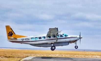 Small aircraft landing on Masai Mara airstrip on a fly-in safari from Nairobi
