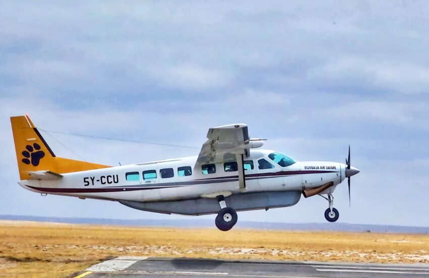 Small aircraft landing on Masai Mara airstrip on a fly-in safari from Nairobi