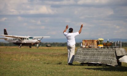 Small aircraft landing on Masai Mara airstrip on a fly-in safari from Mombasa