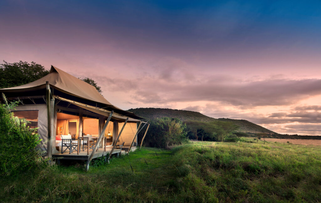 Sunset over the Masai Mara plains seen from a luxury tented camp