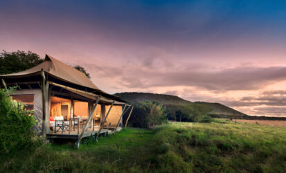 Sunset over the Masai Mara plains seen from a luxury tented camp