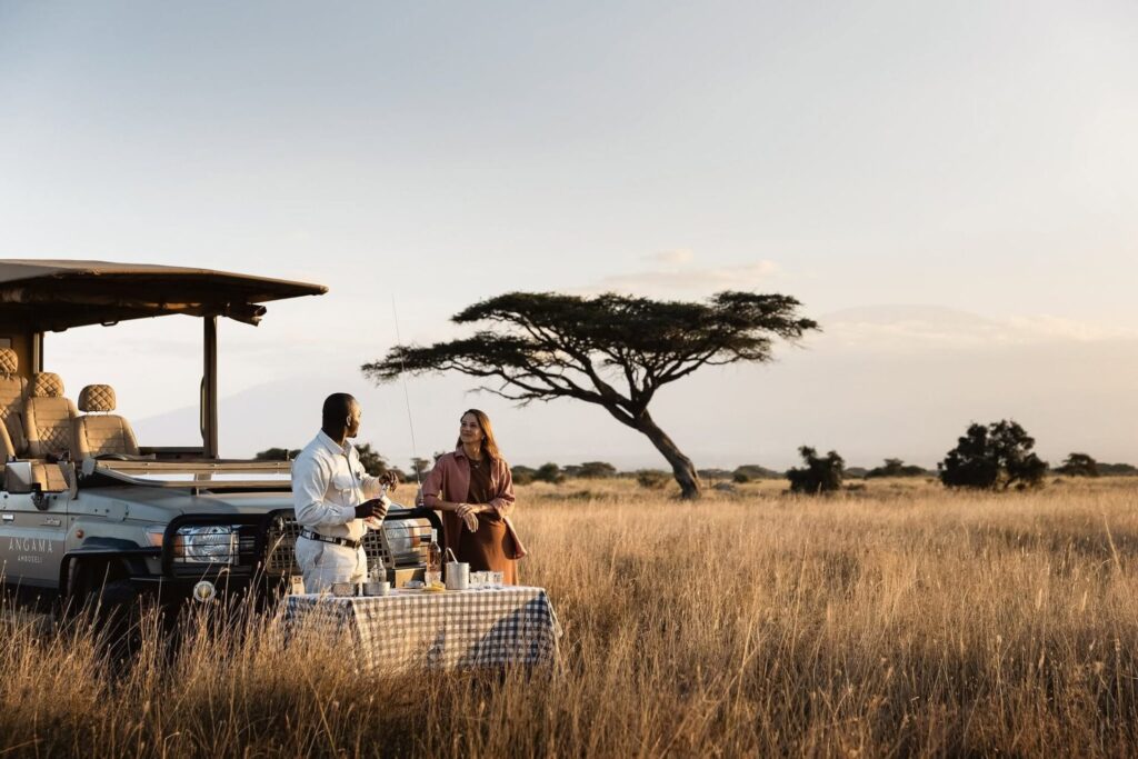 Couple enjoying a romantic bush sundowner during a luxury Kenya Honeymoon Safari in Amboseli