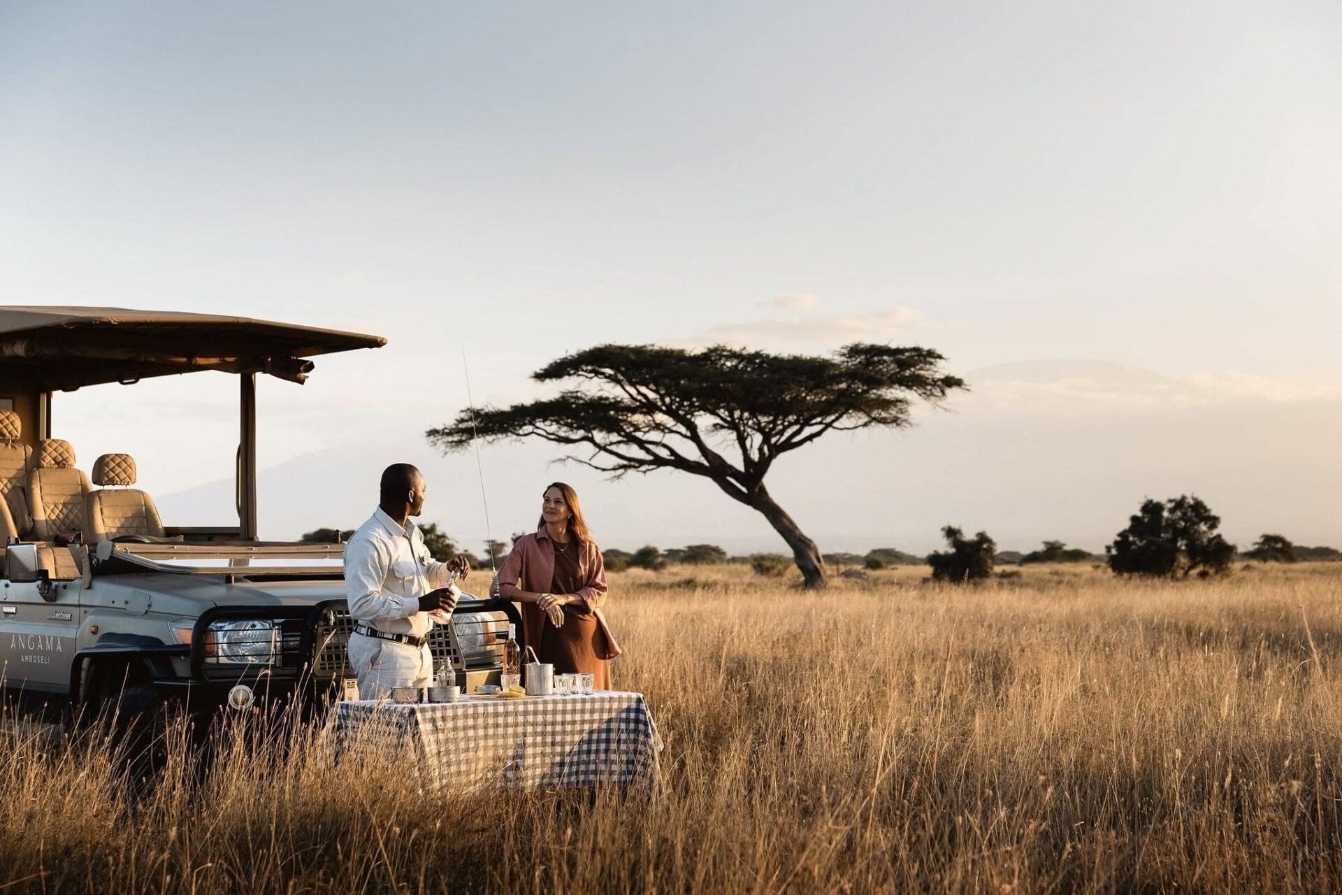 Couple enjoying a romantic bush sundowner during a luxury Kenya Honeymoon Safari in Amboseli